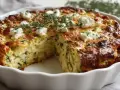 Herzhaftes zucchini mit feta im ofen, goldbraun gebacken und mit frischen Kräutern garniert.