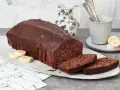 Saftige Schoko-Bananen-Torte mit dunkler Schokoladenglasur, garniert mit Bananenscheiben. Ein Genuss für jeden Kaffeetisch.