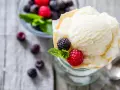 Cremiges Joghurteis selber machen, garniert mit frischen Beeren und Minze. Ein Genuss für heiße Tage!