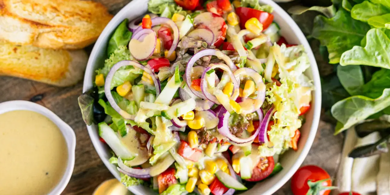 Frischer gemischter Salat mit Tomaten, Gurken, Mais und roten Zwiebeln, perfekt als leichtes Mittagessen. Ein tolles gemischter salat rezept!