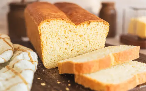 Ein frisch gebackenes, goldbraunes Toastbrot, geschnitten in saftige Scheiben. Das perfekte Ergebnis eines original Toastbrot Rezepts.