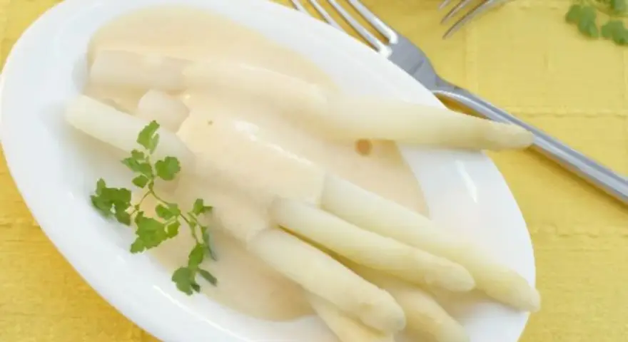 Spargel mit cremiger sauce hollandaise ohne ei, garniert mit Petersilie. Ein Genuss für jeden Gaumen.