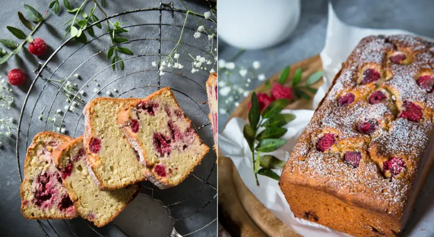 Saftiger Himbeer-Zitronen-Kuchen, bestäubt mit Puderzucker. Auf einem Gitter und auf einem Holzbrett mit frischen Himbeeren und Grün dekoriert.