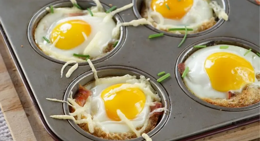 Was isst man zu Ostern? Top 7: Gebackene Eier in Muffinform mit Speck, Käse und Schnittlauch – ein leckeres Osterfrühstück.