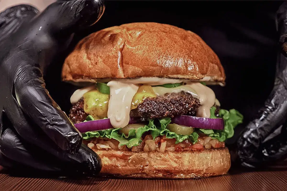 Saftiger Burger mit vielerlei Belag und cremiger, an Big Mac Sauce erinnernder Soße, die über das Patty läuft.