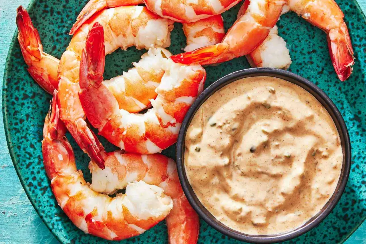 Garnelen auf einem t&uuml;rkisfarbenen Teller mit einer Sch&uuml;ssel cremiger Remoulade. Dieses Remoulade Rezept ist perfekt dazu!